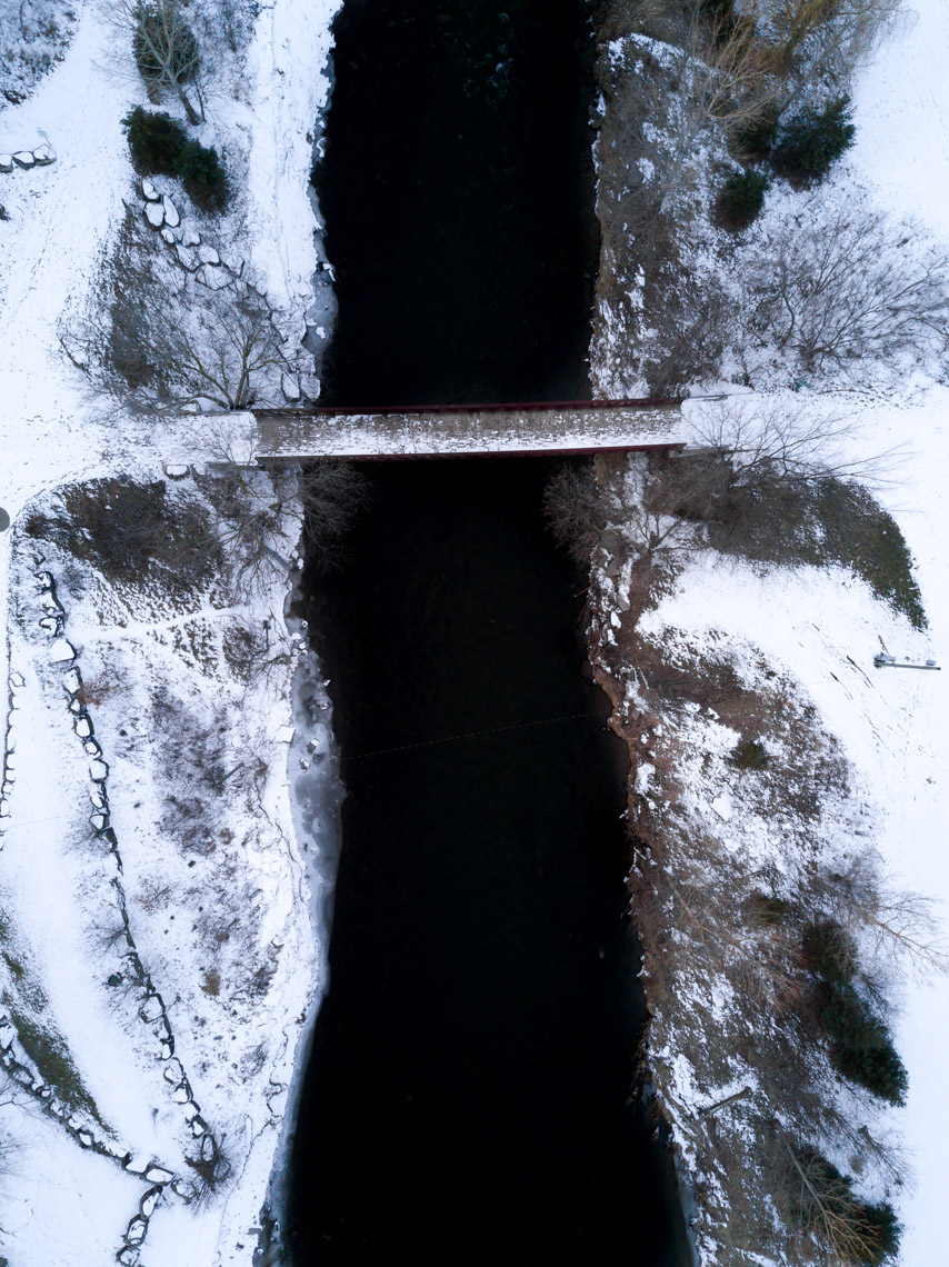 Aerial view of Go Bridge and Credit River in Streetsville in winter 
