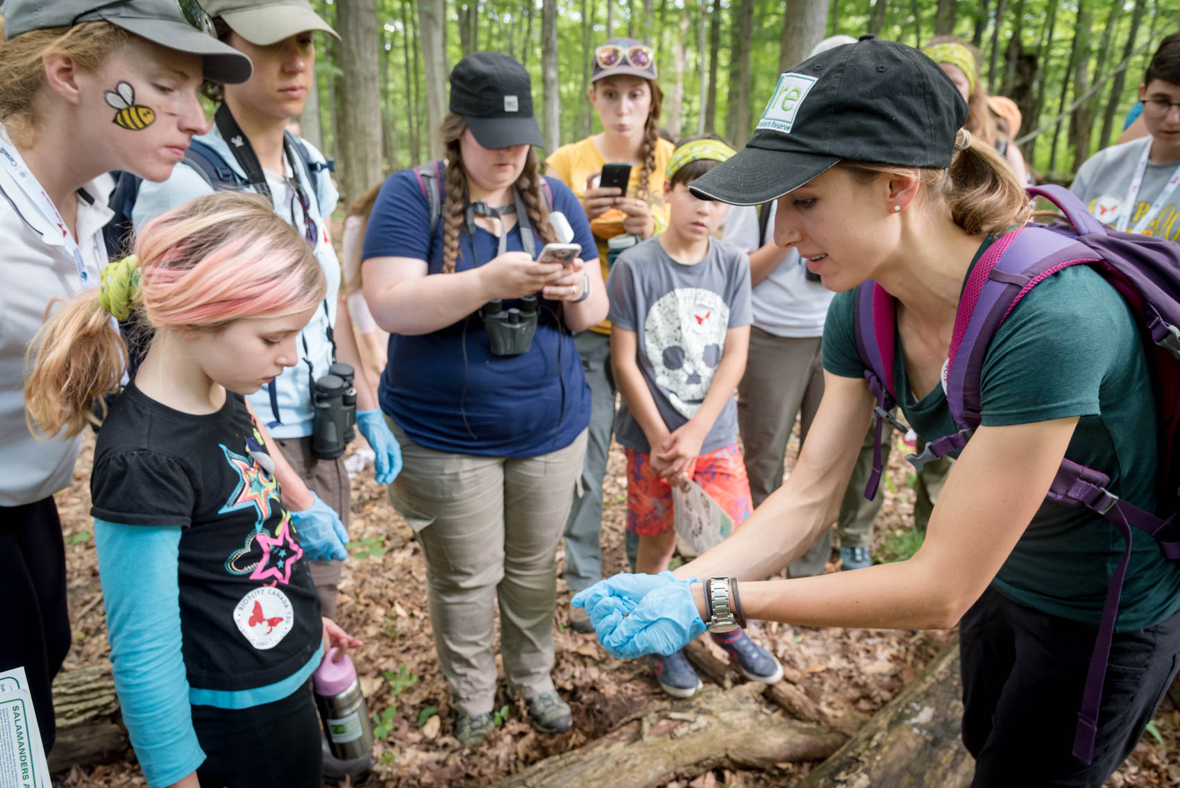 A group looking at a salamander in the hands of a BioBlitz guide © David Coulson conservation photographer