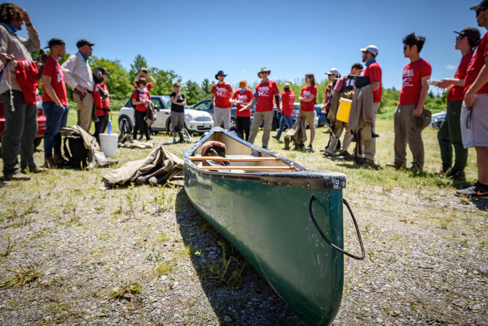 A group of BioBlitz participants surround a canoe at Rough Park 