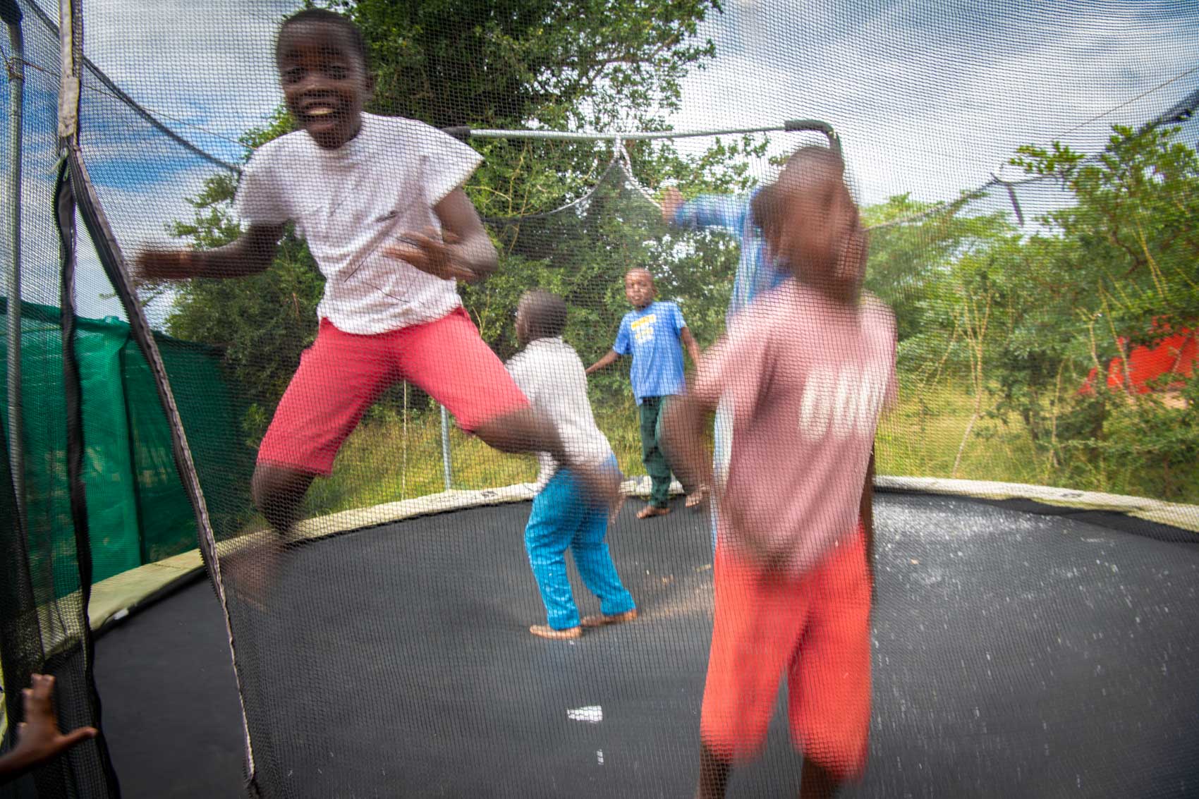 Children jumping on a trampoline at Nourish eco village in South Africa