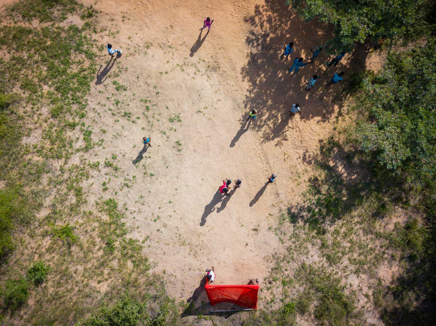 Arial view of children playing soccer at Nourish eco village in South Africa