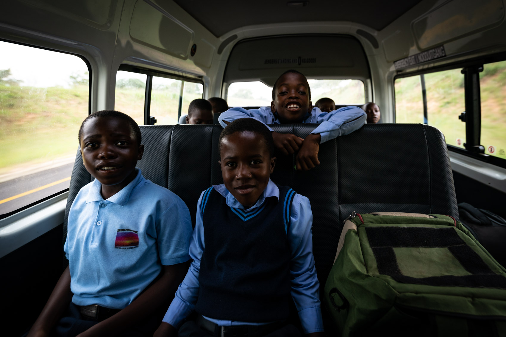 Three African school boys in a van in South Africa